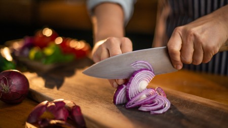 The Clever Trick For Chopping Onions Without Crying According To Alton Brown